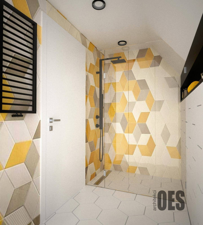 Łazienka z płytkami biało-szaro-żółtymi ułożonymi we wzór geometryczny