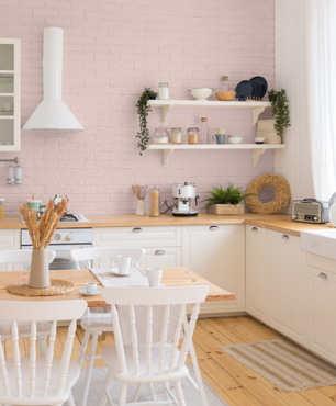 Kuchnia w stylu retro z różowym kolorem na ścianie oraz z meblami z białym frontem