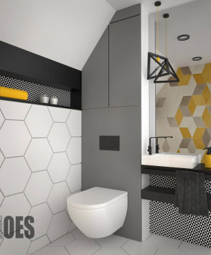 Projekt łazienki z płytkami ułożonymi we wzór heksagonalny oraz z białą muszlą klozetową