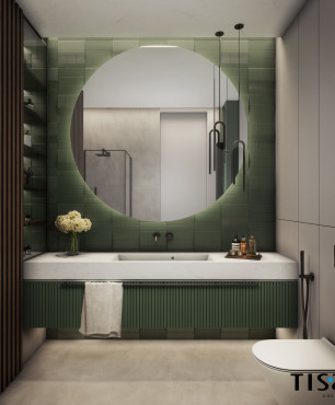 Łazienka z zielonymi płytkami na ścianie z dużym, okrągłym lustrem