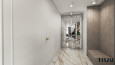 Długi korytarz z dużym, tapicerowanym siedziskiem oraz z marmurową podłogą i pięknymi lustrzanymi drzwiami