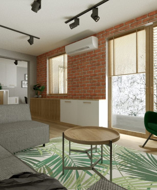Projekt salonu w stylu loft z cegłą na ścianie oraz z zielonym fotelem bujanym