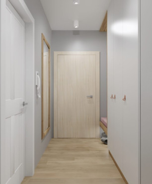 Korytarz z białą szafą z uchylnymi drzwiami oraz z lustrem w drewnianej ramie
