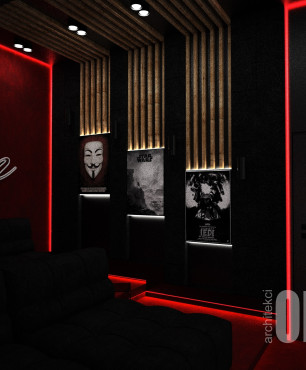 Salon w ciemnej aranżacji z plakatami na ścianie