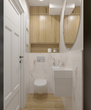 Mała toaleta z białym gresem na ścianie oraz drewnianą szafką wiszącą