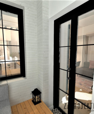 Mały balkon z białą cegłą na ścianie