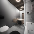 Projekt łazienki z czarnymi, wielkoformatowymi płytkami na ścianie