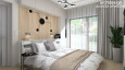 Projekt sypialni z drewnem na ścianie oraz z zabudowanymi szafkami nad łóżkiem