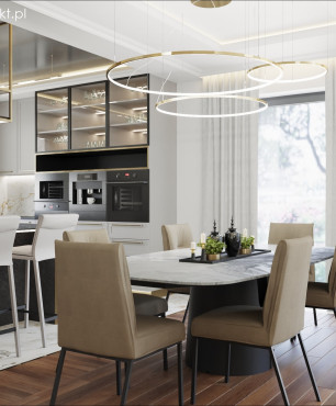 Jadalnia z widokiem na kuchnię w stylu art deco z piękną, złotą lampą wiszącą