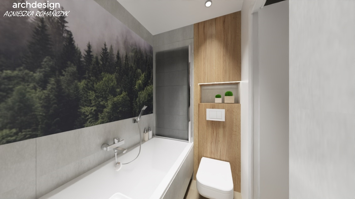 Łazienka wanną w zabudowie oraz z tapetą z motywem lasu na ścianie