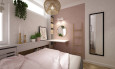 Sypialnia z różowym kolorem ścian oraz z toaletką