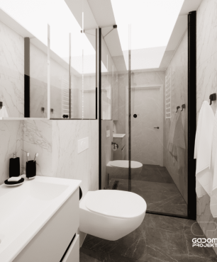 Łazienka z prysznicem oraz szarymi gresowymi płytkami na podłodze