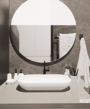 Łazienka z owalną umywalką nablatową oraz okrągłym lustrem