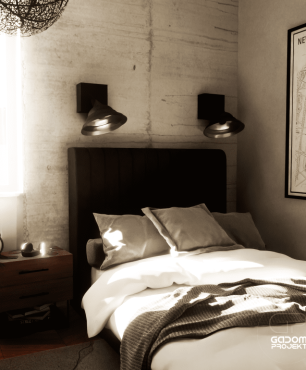 Sypialnia z betonową ścianą oraz czarnymi kinkietami