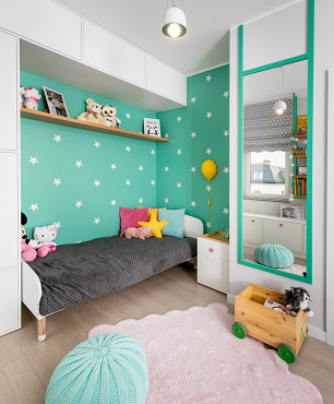 Pokój dziecięcy z zielonym kolorem ścian oraz meblami w zabudowie