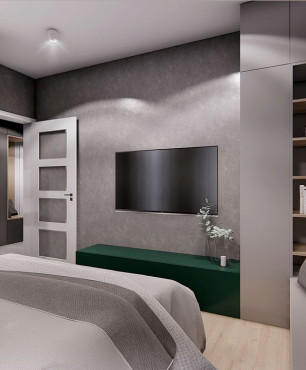 Loftowa sypialnia z betonową ścianą i telewizorem