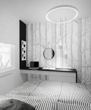 Sypialnia z czarno-białą grafiką drzew na ścianie
