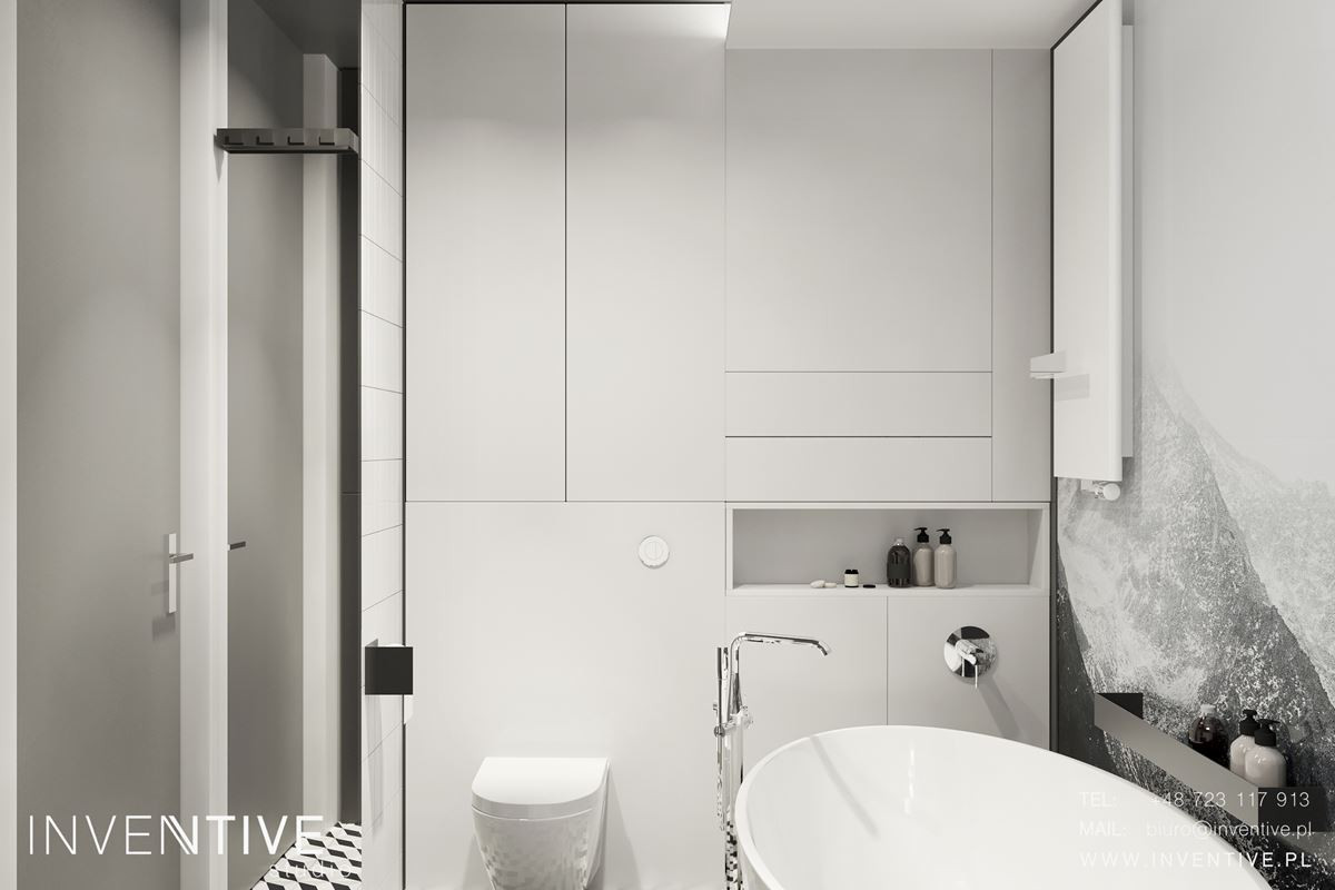 Aranżacja małej łazienki z białą szafką w zabudowie