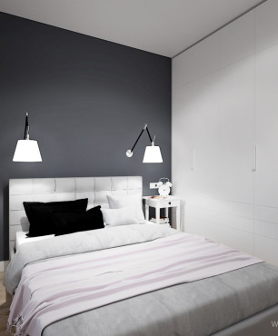 Mała sypialnia z antracytową ścianą