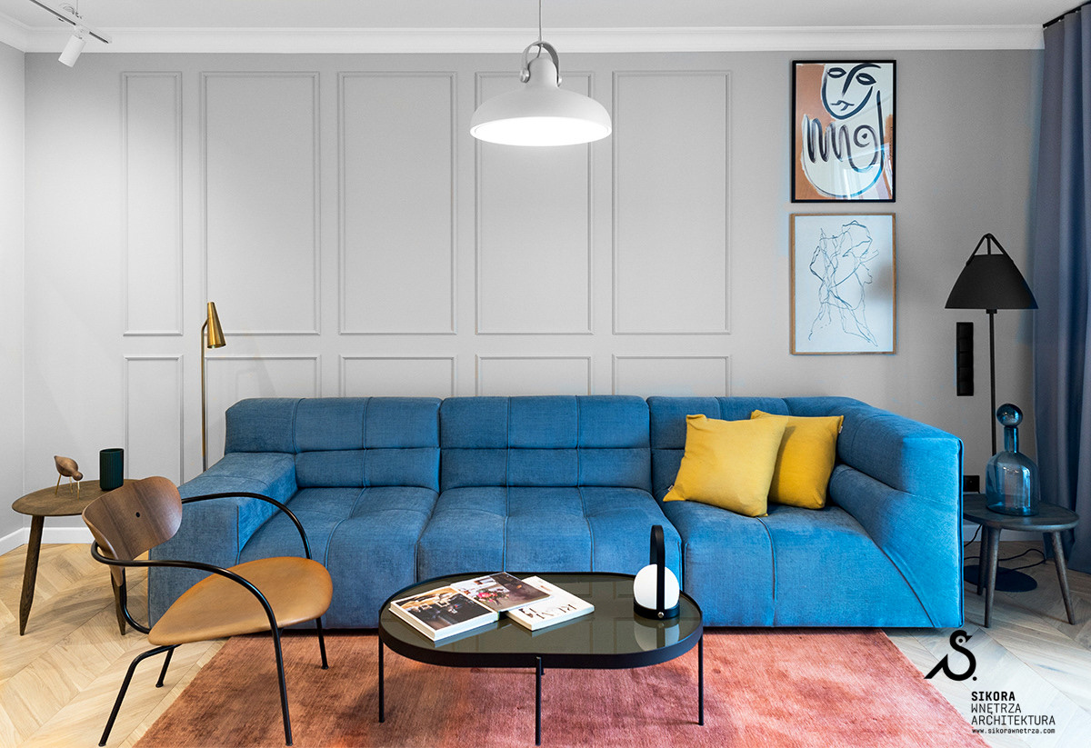 Szary salon z niebieską kanapą