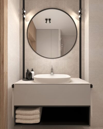 Łazienka z dużym, okrągłym lustrem