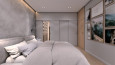 Sypialnia z dużym, tapicerowanym łóżkiem kontynentalnym i garderobą z zasuwanymi drzwiami