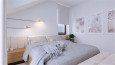 Sypialnia z białymi ścianami i łóżkiem kontynentalnym