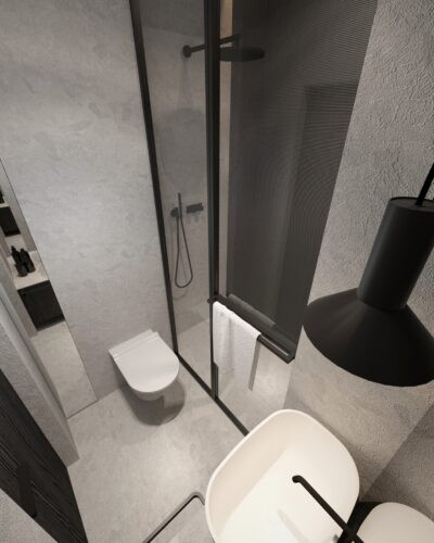 Mała łazienka z prysznicem, muszlą wiszącą i czarną lampą wiszącą