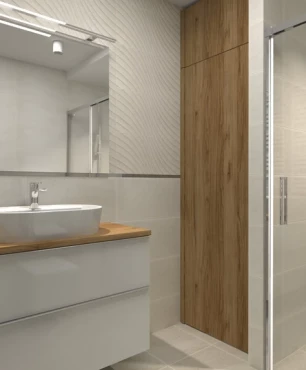 Łazienka z jasnymi płytkami 3d i prysznicem z przesuwanymi drzwiami