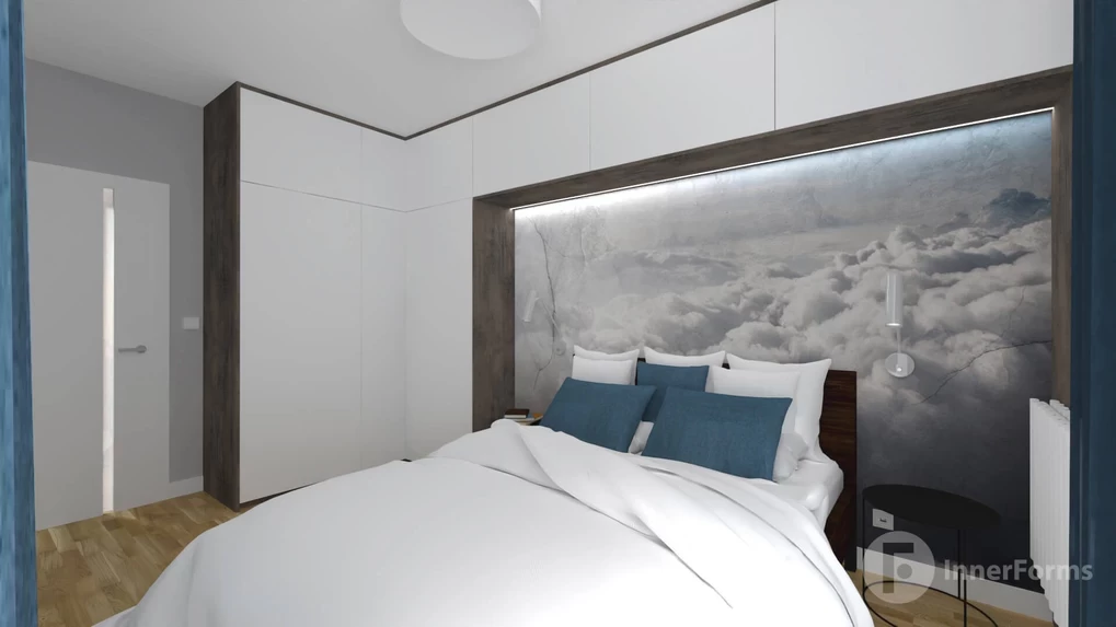 Sypialnia z białą szafą i szafkami w zabudowie z tapetą z motywem nieba