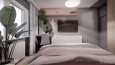 Sypialnia z telewizorem na ścianie i z różową półką