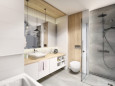 Przestrzenna i funkcjonalna łazienka z prysznicem i szarą podłogą