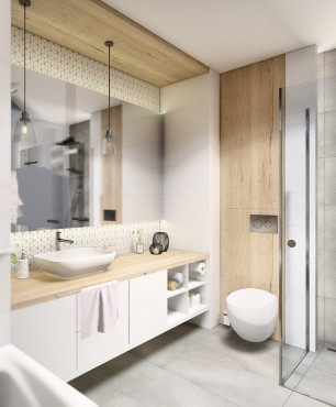 Przestrzenna i funkcjonalna łazienka z prysznicem i szarą podłogą