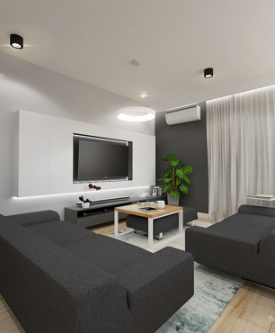 Aranżacja salonu z dużymi sofami i telewizorem na ścianie