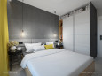 Sypialnia z szarymi ścianami i białą szafą w połysku