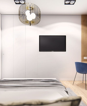 Sypialnia z biurkiem i telewizorem na ścianie