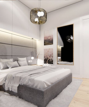 Przestrzenna sypialnia z tapicerowaną ścianą i łóżkiem kontynentalnym